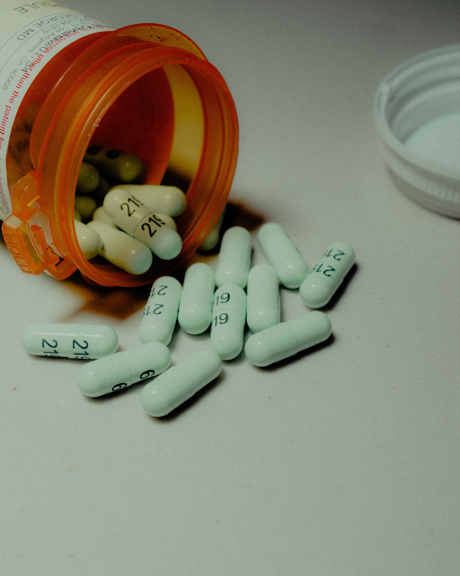 pills spilling out of a bottle on a table